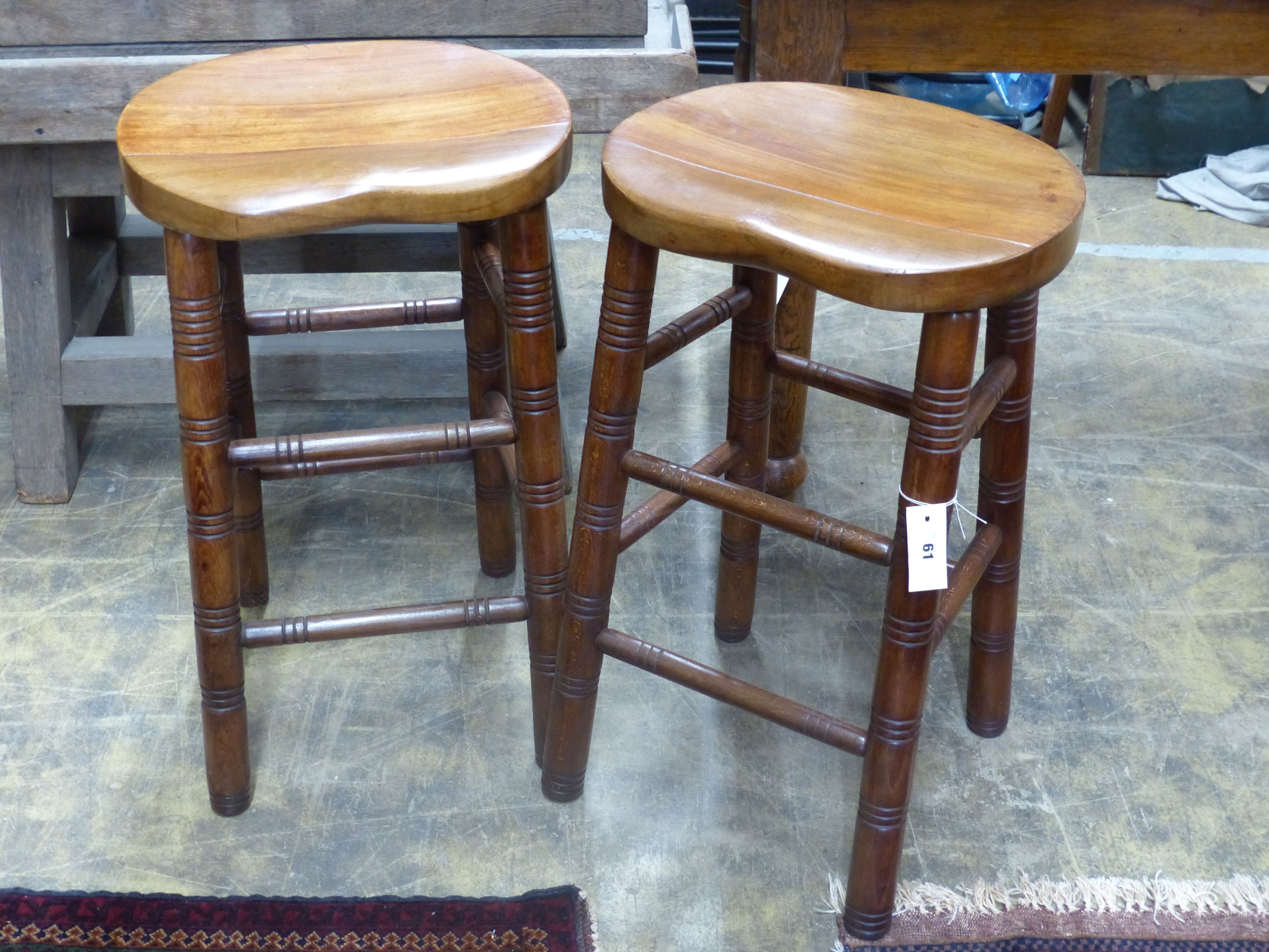 A pair of beech stained bar stools, width 40cm, depth 32cm, height 68cm